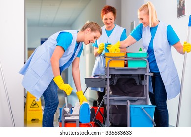 Commercial Cleaning Brigade Working In Corridor