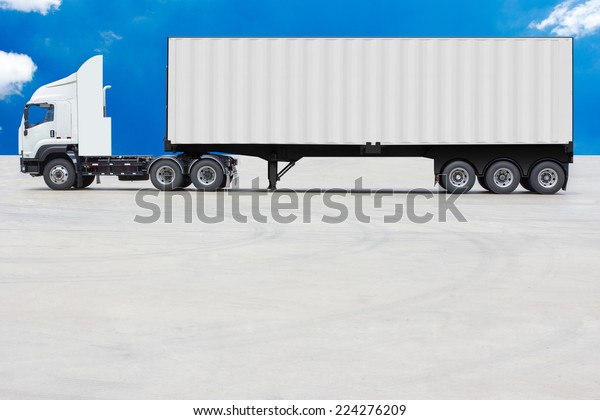 commercial delivery cargo container truck with white\
trailer against blue sky\
