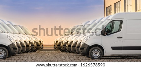 commercial delivery vans parked in two rows. Transporting service company.