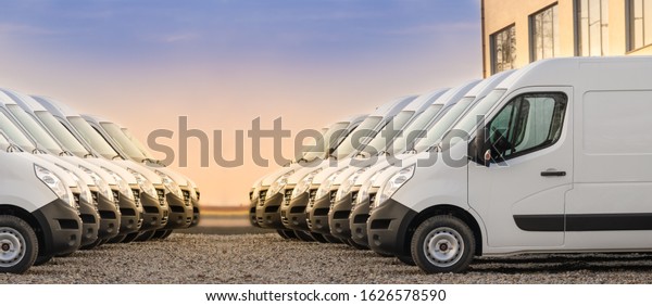 commercial delivery vans parked in two rows.\
Transporting service\
company.