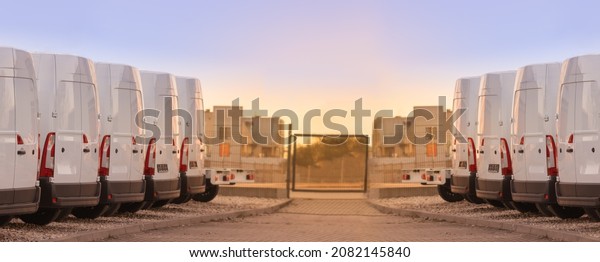 commercial delivery vans parked in two rows.\
Transporting service\
company.