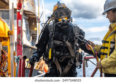 Commercial diver exiting water at harbor closeup