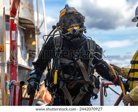 Commercial Diver moving out from water after work