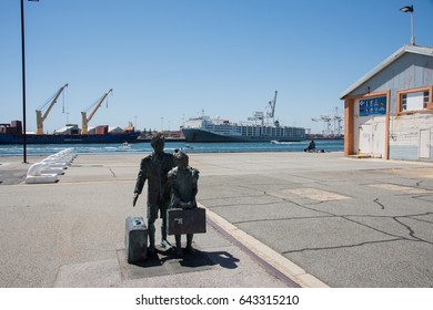 Commercial Dock, Cranes, And Sculpture In Fremantle, Western Australia/Migrant Sculpture/ FREMANTLE,WA,AUSTRALIA-NOVEMBER 13,2016: Dock, Cranes And Migrant Sculpture In Fremantle,Western Australia