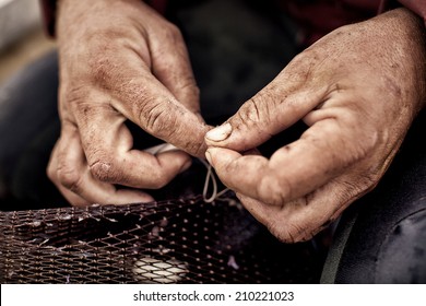 Commercial Fisherman Repairing His Eel Nets