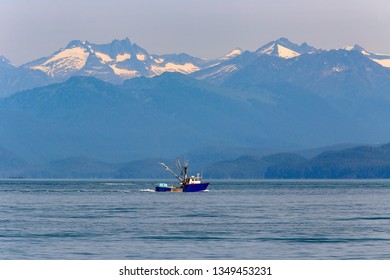 Commercial Fishing Boat - Trawler In Pacific Ocean With Snow Moutains In Background. Juneau ,Alaska