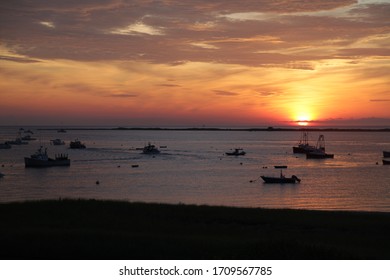 A Commercial Fishing Fleet Gets Underway At Sun's First Light Over The Bay.  