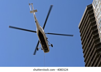 Commercial Helicopter In Flight Over The City