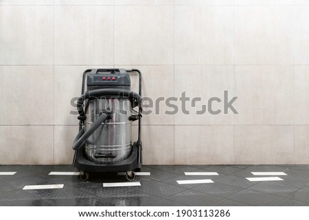 Commercial hoover next to the wall at car wash. Copy space for text. Commercial vacuum cleaner, self service.