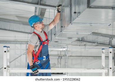 Commercial HVAC Systems Installation Inside The Warehouse Performed By Caucasian Heating And Cooling Technician In His 40s.