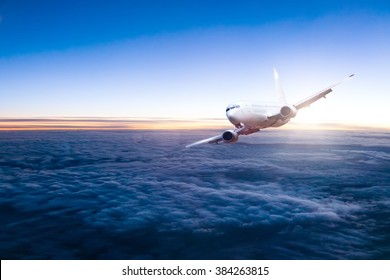 Commercial Jet Aeroplane Flying Above Clouds