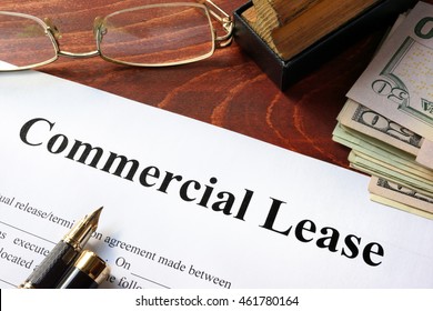 Commercial Lease agreement with money on a table.