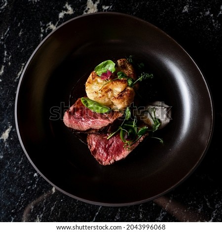 Commercial photo of buffalo steak on posh marble background, elegant atmosphere of a posh restaurant