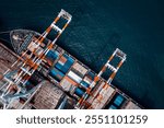 commercial port in black sea load, unloading cargo from container ship import export by crane for distributing goods by trailers transport logistic  to customers and dealers, cinematic tone process, 