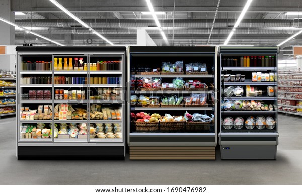 Commercial refrigerators different types of fridges.\
Photo, mock-up, Planogram. Juice, coffee and yoghurt in bottles and\
cans. Fresh Vegetable, sandwiches, fruits in plastic bottles at\
supermarket. 