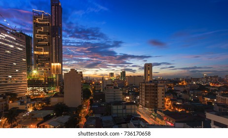 Commercial and residential buildings and structures in the cities of Makati, Manila during last light sunset.
