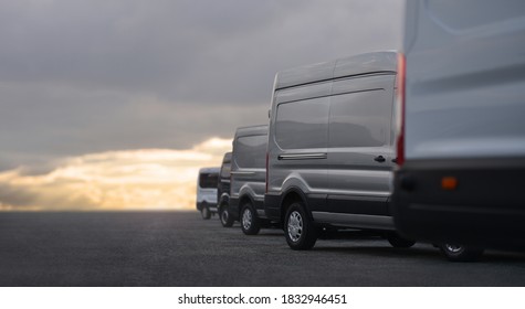 Commercial Vans In Row On Dealership Parking