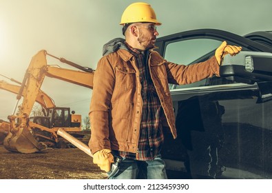 Commercial Vehicle in Use by Professional Contractor Worker. Caucasian Men Wearing Hard Hat and Safety Glasses Staying Next to His Pickup Truck.