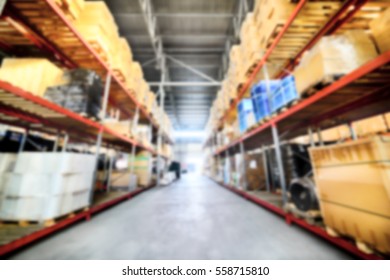Commercial warehouse. Long shelves with a variety of boxes and containers. Deep blur effect.