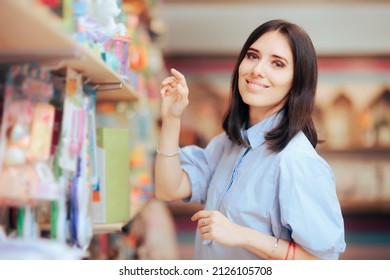 
				Commercial Worker Arranging Goods on the Shelf. Happy woman working retail job standing by the products 
				