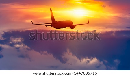 Commerical airplane in the sky at sunrise