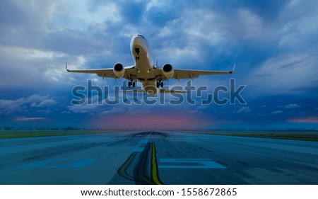 Commerical airplane taking off from airport runways for traveling with stormy weather