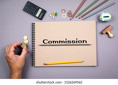 Commission concept. Notepad and stationery on gray table - Shutterstock ID 1526269562