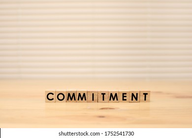 Commitment, word text typography written on wooden alphabet letterpress cubes 
