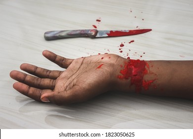 Committed Suicide Concept - Man Suicide By Knife Cutting A Wrist, Depressed Man, Sad Love, Low Self Esteem, The Knife Hand And A Lot Of Blood. To Cut My Veins On The Hand With A Kitchen Knife.