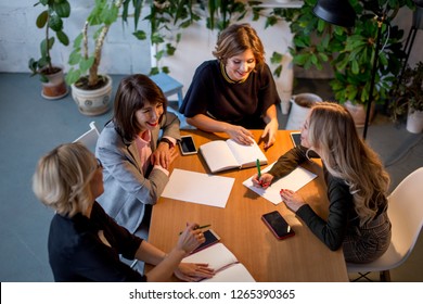 Committee of experts consisting of experienced professional female fashion designers and tailors of fashion female clothes meet at the office to choose the winner of Fashion Week at their city. - Powered by Shutterstock