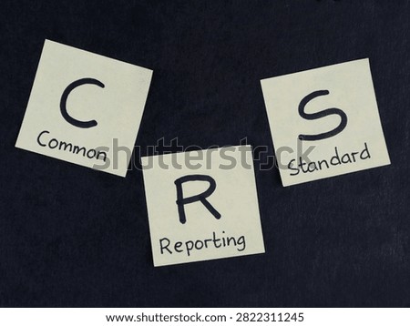 Commo Reporting and Standard (CRS) on yellow adhesive notes arranged on black background. Business, legal, and financial concept international tax compliance and automatic exchange of information