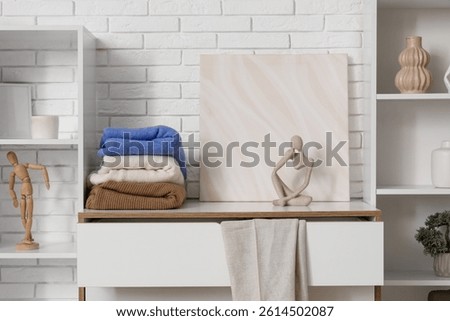 Commode with clothes and decor in dressing room
