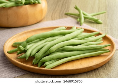 Common bean,Bush beans are french green beans in wooden plate.