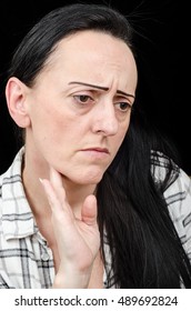 Common Cold / Flu. Woman Checking For Swollen Glands In Her Neck. Black Background With Copy Space.