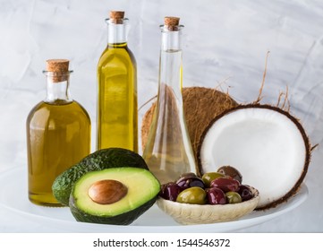 Common healthy cooking oils including avocado oil, olive oil and coconut oil. Healthy fat concept.