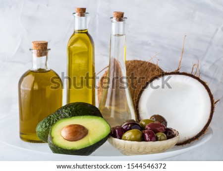 Common healthy cooking oils including avocado oil, olive oil and coconut oil. Healthy fat concept.