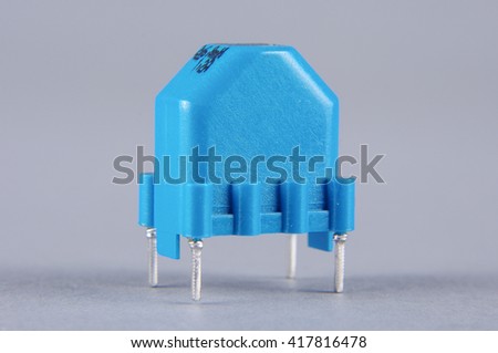 Common mode choke electronic component isolated on the gray background