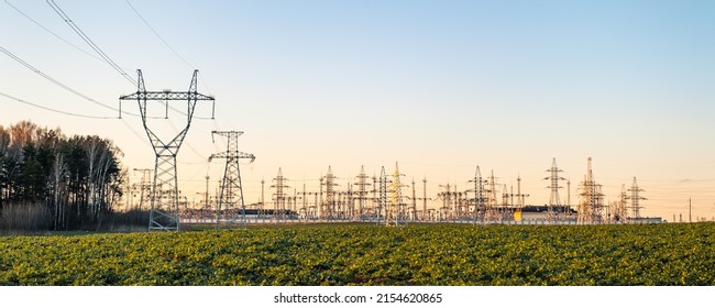 Common view on the power station. Poles with wires. Large electric transformer. Electricity production and supply. High voltage zone. Protected industrial object. City infrastructure. Technogenic.