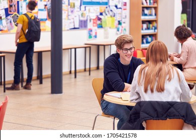 Communal Area Of Busy College Campus With Students Working At Tables