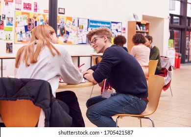 Communal Area Of Busy College Campus With Students Working At Tables