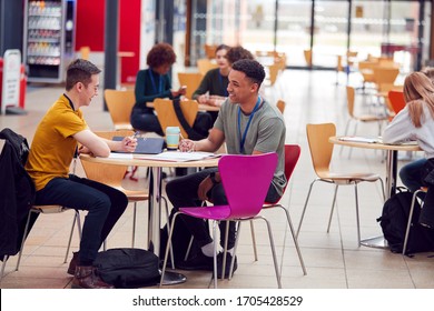 Communal Area Of Busy College Campus With Students Working At Tables