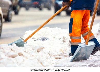 Communal services workers sweep snow from road in winter, Cleaning city streets and roads during snowstorm. Moscow, Russia