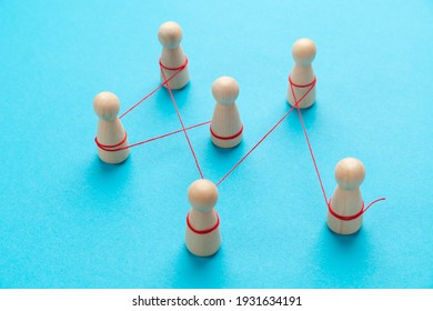Communication between people. The figures are tied with a red thread. spreading rumors. - Shutterstock ID 1931634191