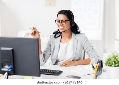 communication, business, people and technology concept - smiling businesswoman or helpline operator with headset and computer at office