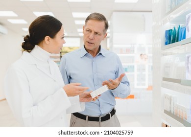 Communication consultation between male customer buyer and female druggist pharmacist at drugstore. Caucasian female chemist advising new medicines to client