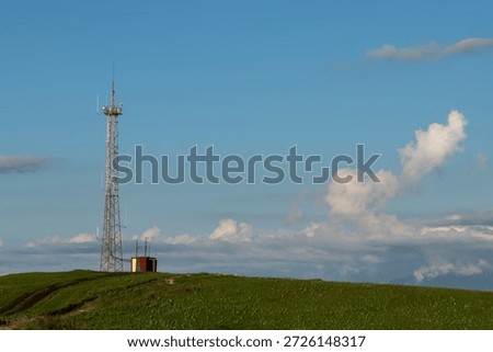 A communication mast for internet and cellular data transmission on a hill