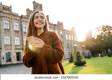 Communication online using smart mobile phone digital technology, young pretty teenager student typing massage in social networks or making post on her account page. Happy smile and lifestyle people