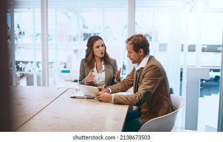 Communication Is The Only Way Forward. Cropped Shot Of Two Businesspeople Working Together In The Boardroom.