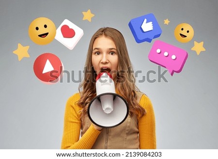 communication, social media and people concept - teenage girl speaking to megaphone over internet icons on grey background