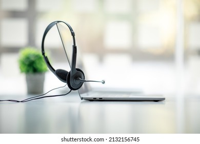 Communication support, call center, and customer service help desk. VOIP headset on a laptop computer, Helpdesk or call center headset minimal concept banner